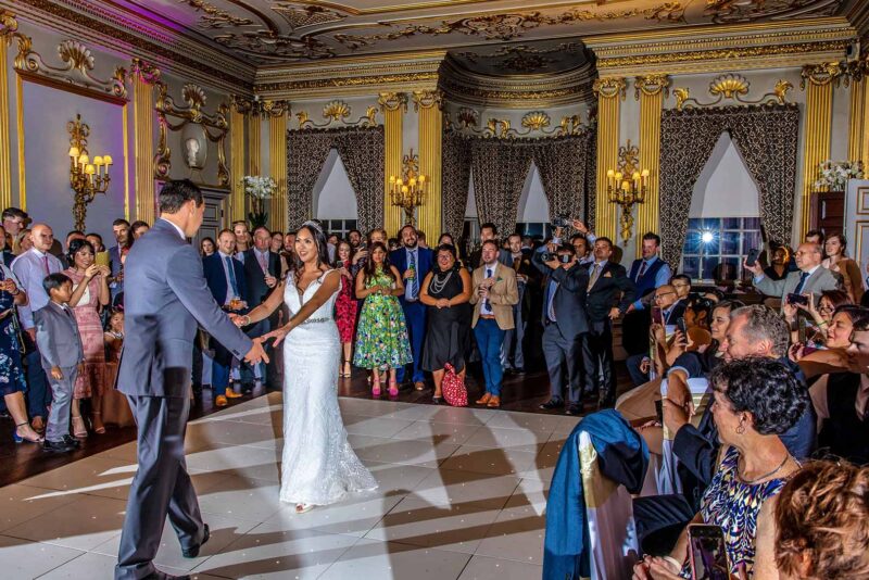 Bride and Groom in a Ballroom having their first dance on their wedding day