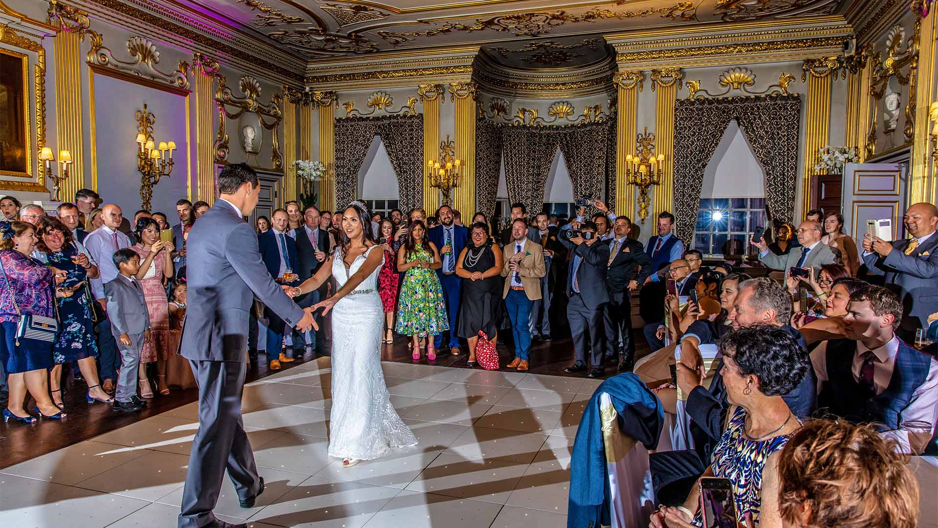 Bride and Groom in a Ballroom having their first dance on their wedding day
