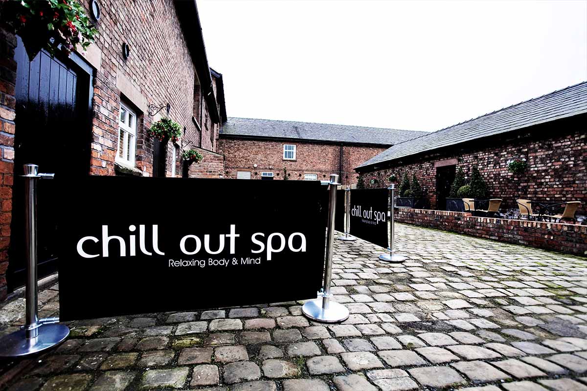 Cobbled stones with seating and signs for Chill Out Spa